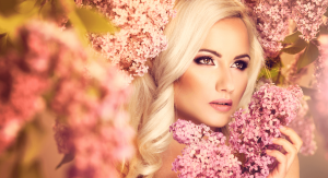 Beautiful Blonde woman surrounded by flowers with enhanced natural beauty after cosmetic injectables.