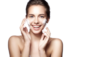 smiling woman with facial cleanser on her face