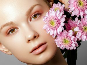 Yong woman with pink flowers | Medical Spa